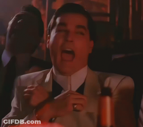 A Man In A Suit With His Mouth Open GIF
