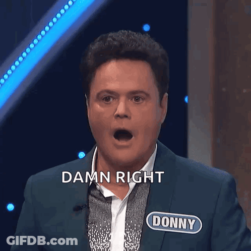 A Man In A Suit With The Name Donny On His Chest GIF