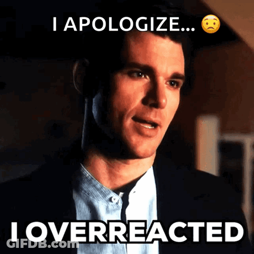 Man In Suit With I Overreacted Below Him GIF