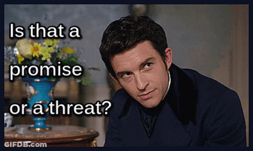 A Man In A Suit With The Words Is That A Promise Or A Threat Written Below Him GIF