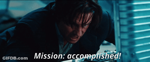 A Man In A Suit With The Words Mission Accomplished On The Bottom GIF