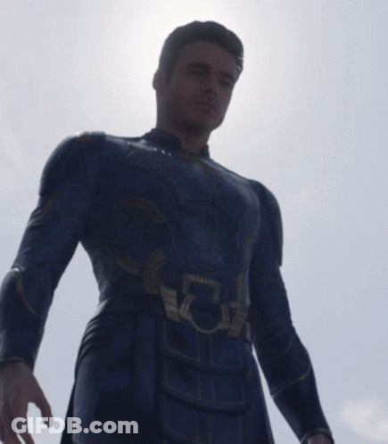 A Man In A Superhero Costume Has A Light Coming Out Of His Eye GIF