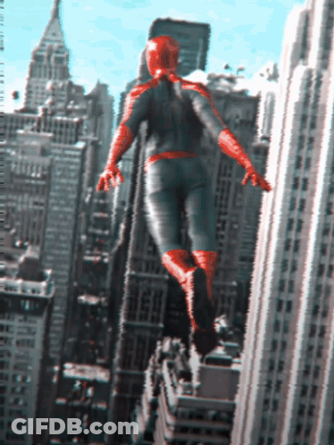 A Man In A Superhero Costume Is Flying Through The Air Over A City GIF