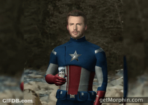A Man In A Superhero Costume Is Holding A Can Of Drink GIF