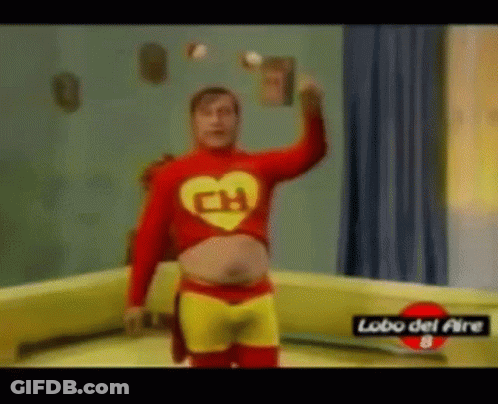 A Man In A Superhero Costume Is Juggling A Book . GIF