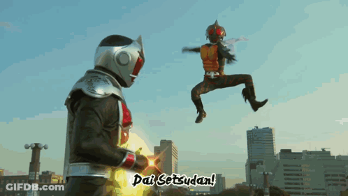 A Man In A Superhero Costume Is Jumping In The Air While Another Man Says Dai Setzudan GIF
