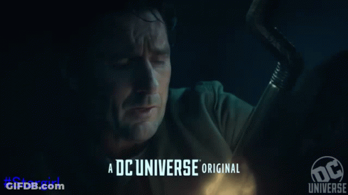 A Man In A Superhero Costume Is Laying On The Ground GIF