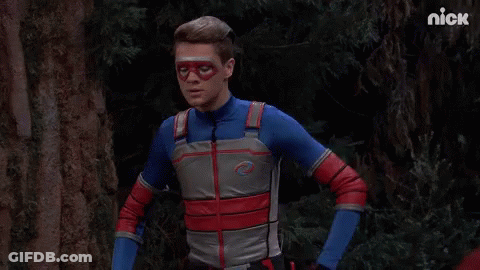 A Man In A Superhero Costume Is Standing In A Forest With The Nick Logo In The Corner GIF