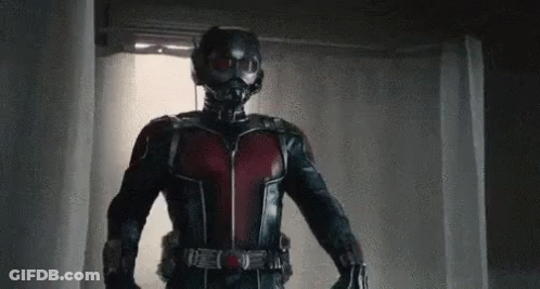 Man In Superhero Costume Holding Gun GIF