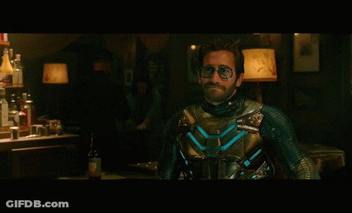 A Man In A Superhero Costume Is Standing In Front Of A Bar GIF