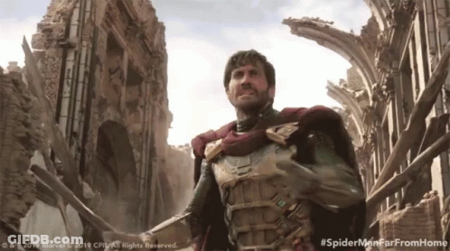 A Man In A Superhero Costume Is Standing In Front Of A Ruined Building With The Hashtag #Spidermenfarfromhome GIF
