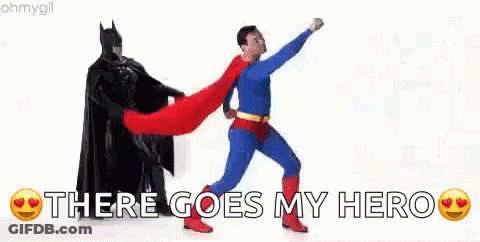 A Man In A Superhero Costume Is Standing Next To A Man In A Batman Costume . GIF