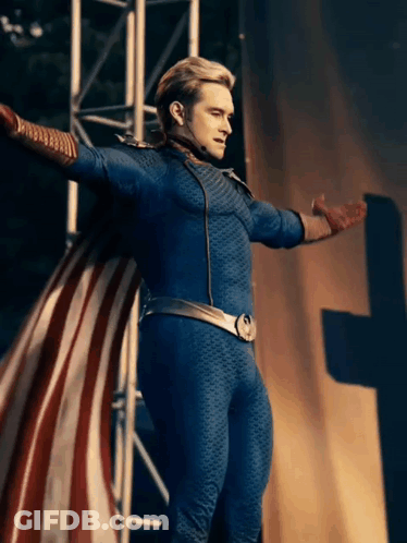 A Man In A Superhero Costume Is Standing With His Arms Outstretched GIF