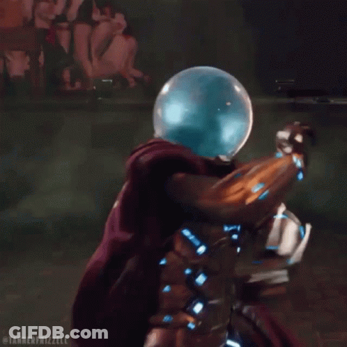 A Man In A Superhero Costume Is Surrounded By Green Smoke And A Glass Ball On His Head . GIF