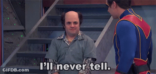 A Man In A Superhero Costume Is Talking To A Bald Man In A Prison Uniform . GIF