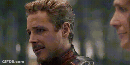 A Man In A Superhero Costume Is Talking To Another Man In A Room . GIF