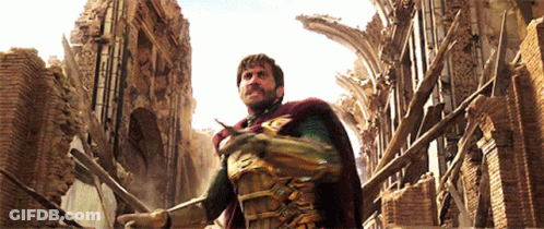A Man In A Superhero Costume Stands In Front Of A Brick Building GIF