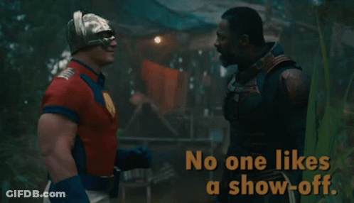 A Man In A Superhero Costume Talks To Another Man With The Words No One Likes A Show-Off GIF