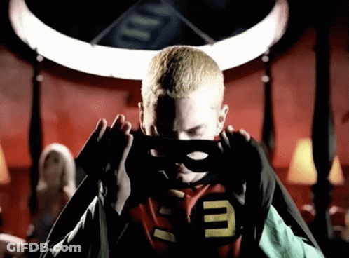 A Man In A Superhero Costume With The Letter E On His Chest GIF