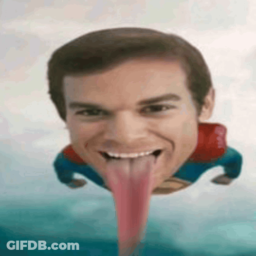 A Man In A Superman Costume Is Sticking Out His Tongue GIF