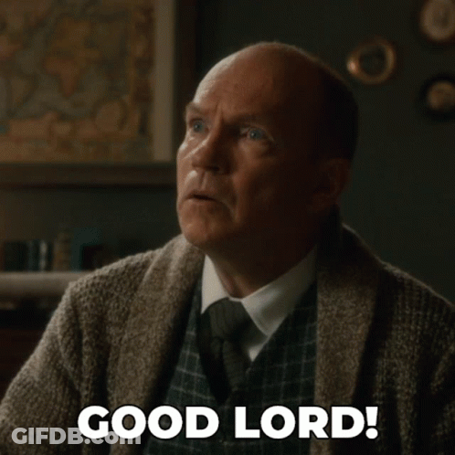 A Man In A Sweater And Tie Is Saying Good Lord GIF