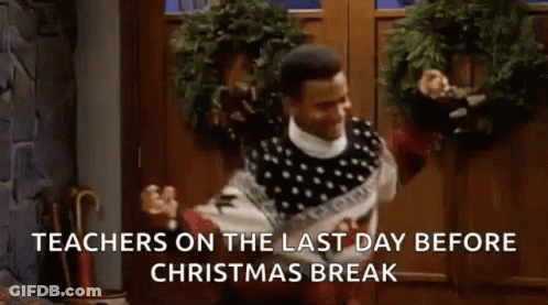 A Man In A Sweater Is Dancing In Front Of A Door With A Christmas Wreath . GIF