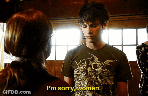 A Man In A T-Shirt That Says I 'M Sorry Women Is Talking To A Woman GIF