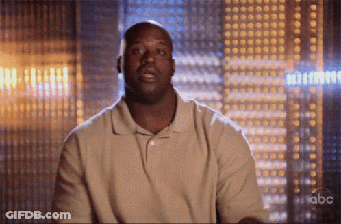 A Man In A Tan Shirt Is Sitting In Front Of A Abc Sign GIF