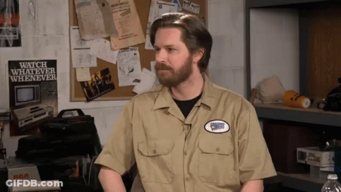 A Man In A Tan Shirt With A Patch That Says Watch Whatever Whenever GIF