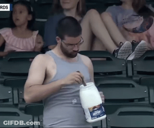 A Man In A Tank Top Holds A Container Of Mayonnaise GIF