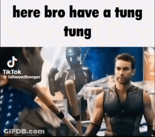 A Man In A Tank Top Is Holding A Bunch Of Baseball Bats In His Hands . GIF