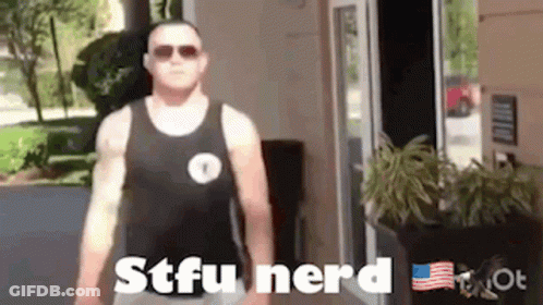 A Man In A Tank Top Is Standing In Front Of A Door . GIF
