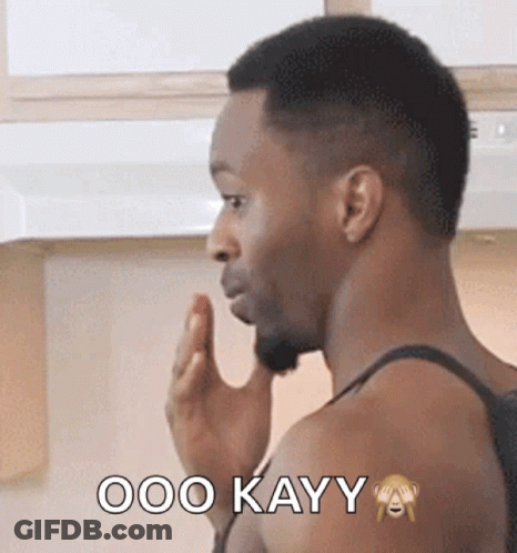 A Man In A Tank Top Says Ooo Kayy With A Monkey On His Arm GIF
