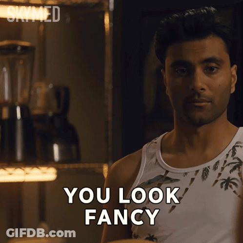 A Man In A Tank Top Says " You Look Fancy " In Front Of A Blender GIF