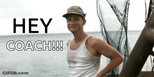A Man In A Tank Top Stands In Front Of A Sign That Says " Hey Coach " GIF