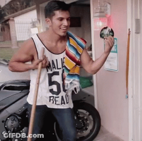 A Man In A Tank Top With The Number 50 On It Is Holding A Broom . GIF