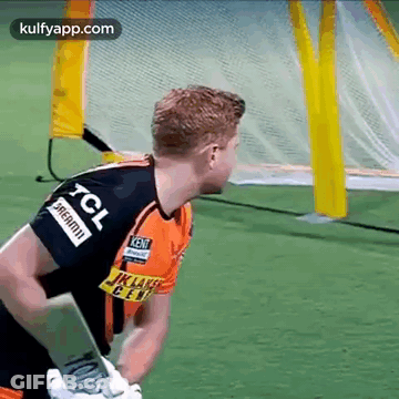 A Man In A Tcl Jersey Is Holding A Cricket Bat . GIF