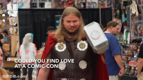 A Man In A Thor Costume Holds A Hammer And Says " Could You Find Love At A Comic-Con " GIF