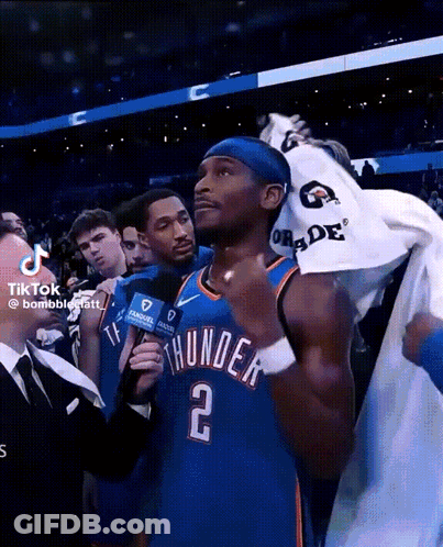 A Man In A Thunder Jersey Is Being Interviewed GIF