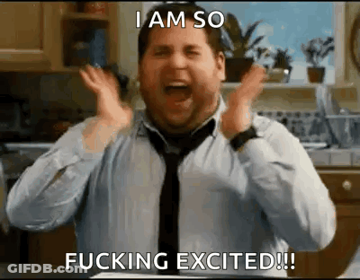 A Man In A Tie Is Making A Funny Face In A Kitchen . GIF