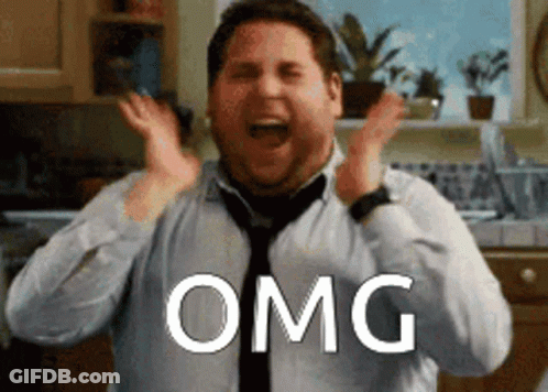 A Man In A Tie Is Making A Surprised Face And The Word Omg Is Above Him GIF