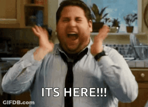 A Man In A Tie Is Screaming In A Kitchen And Saying `` It 'S Here '' . GIF