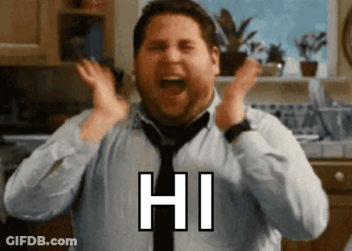 A Man In A Tie Is Screaming With His Hands In The Air And Says Hi GIF