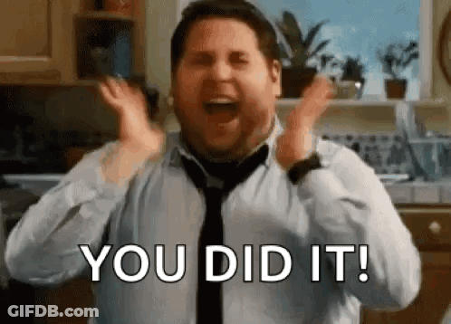 A Man In A Tie Is Screaming With His Hands In The Air . GIF