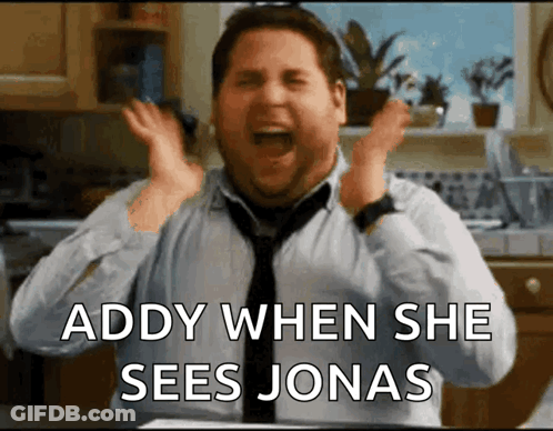 A Man In A Tie Is Screaming With The Words " Addy When She Sees Jonas " Above Him GIF