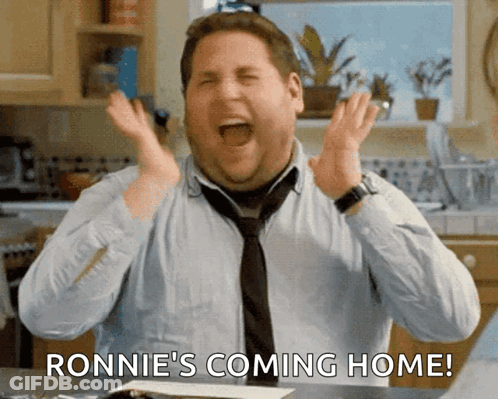 A Man In A Tie Is Screaming With The Words Ronnie 'S Coming Home Below Him GIF