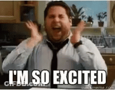 A Man In A Tie Is Sitting In A Kitchen With His Hands In The Air And Says I 'M So Excited GIF