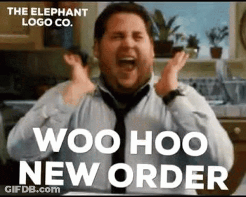 A Man In A Tie Is Sitting In A Kitchen With His Hands In The Air And Screaming . GIF