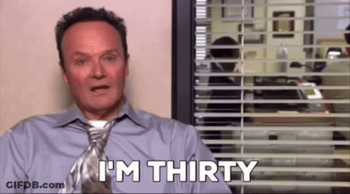 A Man In A Tie Is Sitting In Front Of A Window With Blinds And Says `` I 'M Thirty '' . GIF