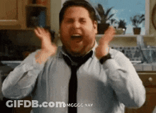 A Man In A Tie Is Standing In A Kitchen With His Arms Outstretched . GIF
